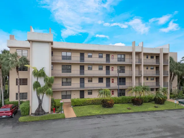 a front view of a residential apartment building with a yard