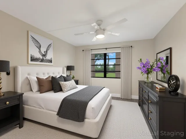 a bedroom with a bed and a large window