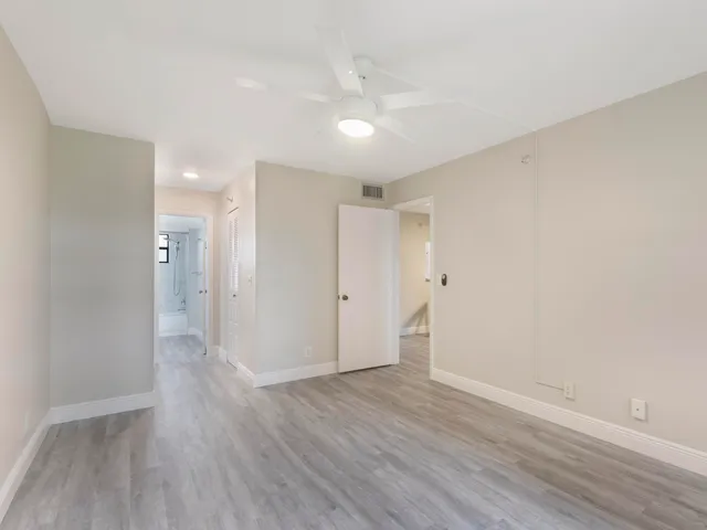 a view of an empty room with wooden floor