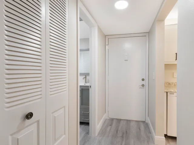 a view of a hallway with wooden floor