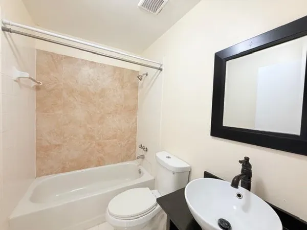 a bathroom with a toilet a sink and a bathtub