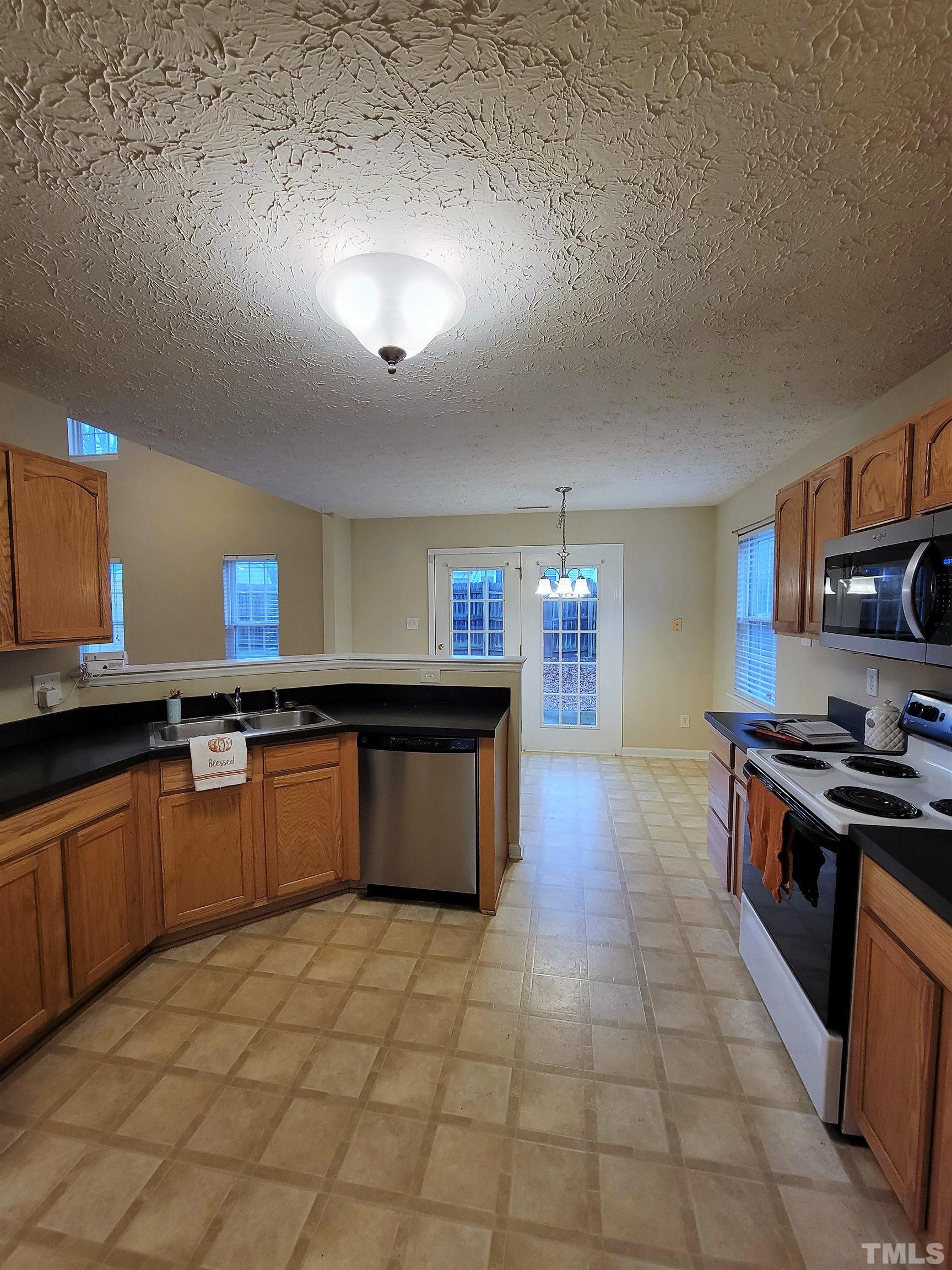 4237 Palafox Court Raleigh, NC 27604 - Photo 2 of 20 a kitchen with stainless steel appliances granite countertop a stove a sink a counter space and cabinets