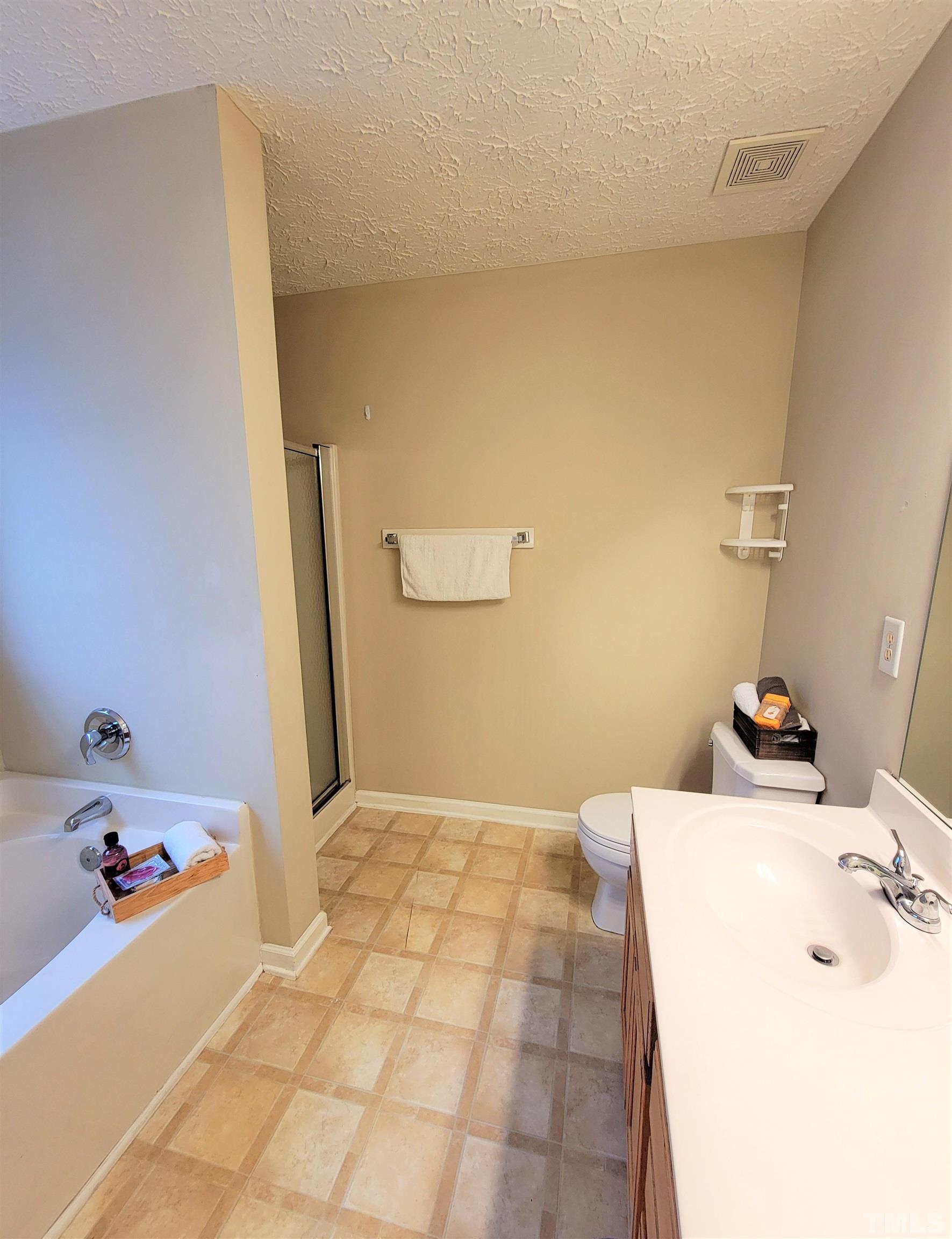 4237 Palafox Court Raleigh, NC 27604 - Photo 14 of 20 a bathroom with a bathtub sink and mirror