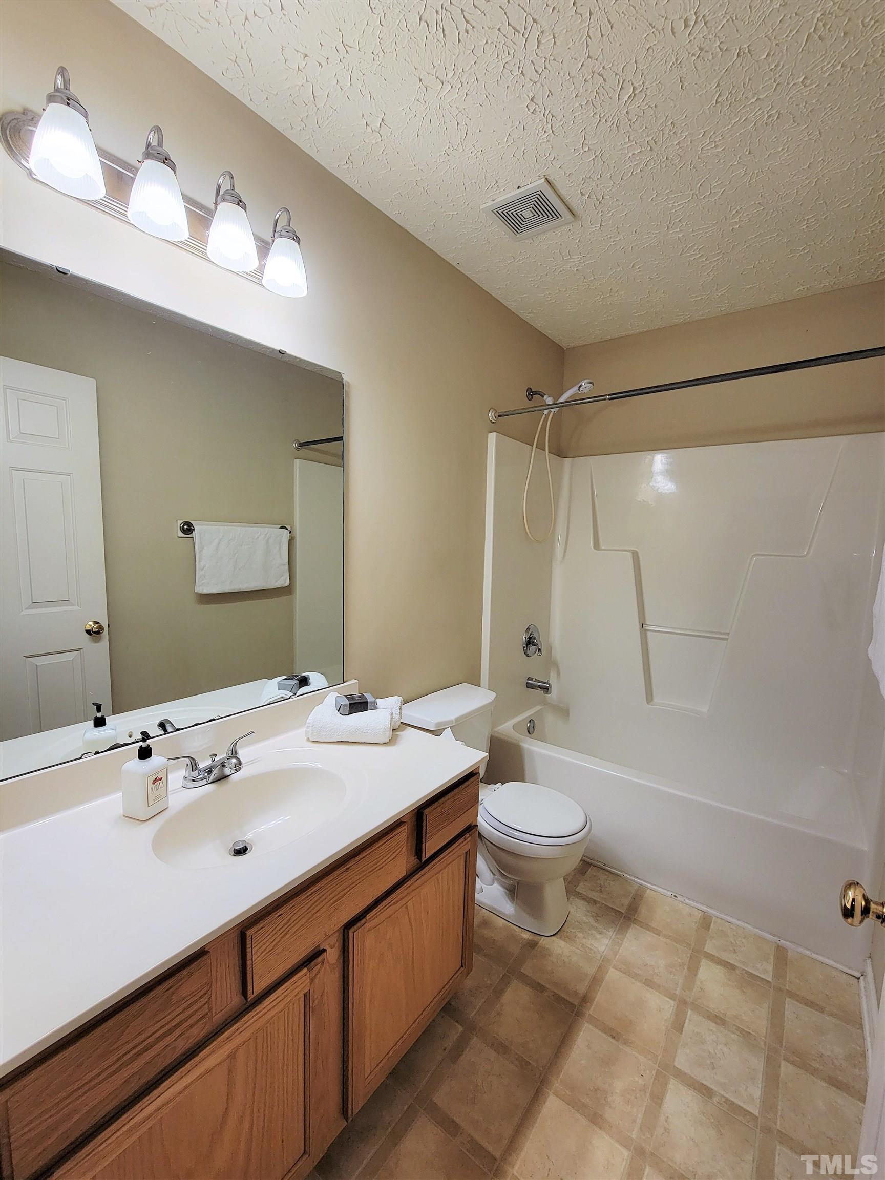 4237 Palafox Court Raleigh, NC 27604 - Photo 18 of 20 a bathroom with a double vanity sink toilet and shower