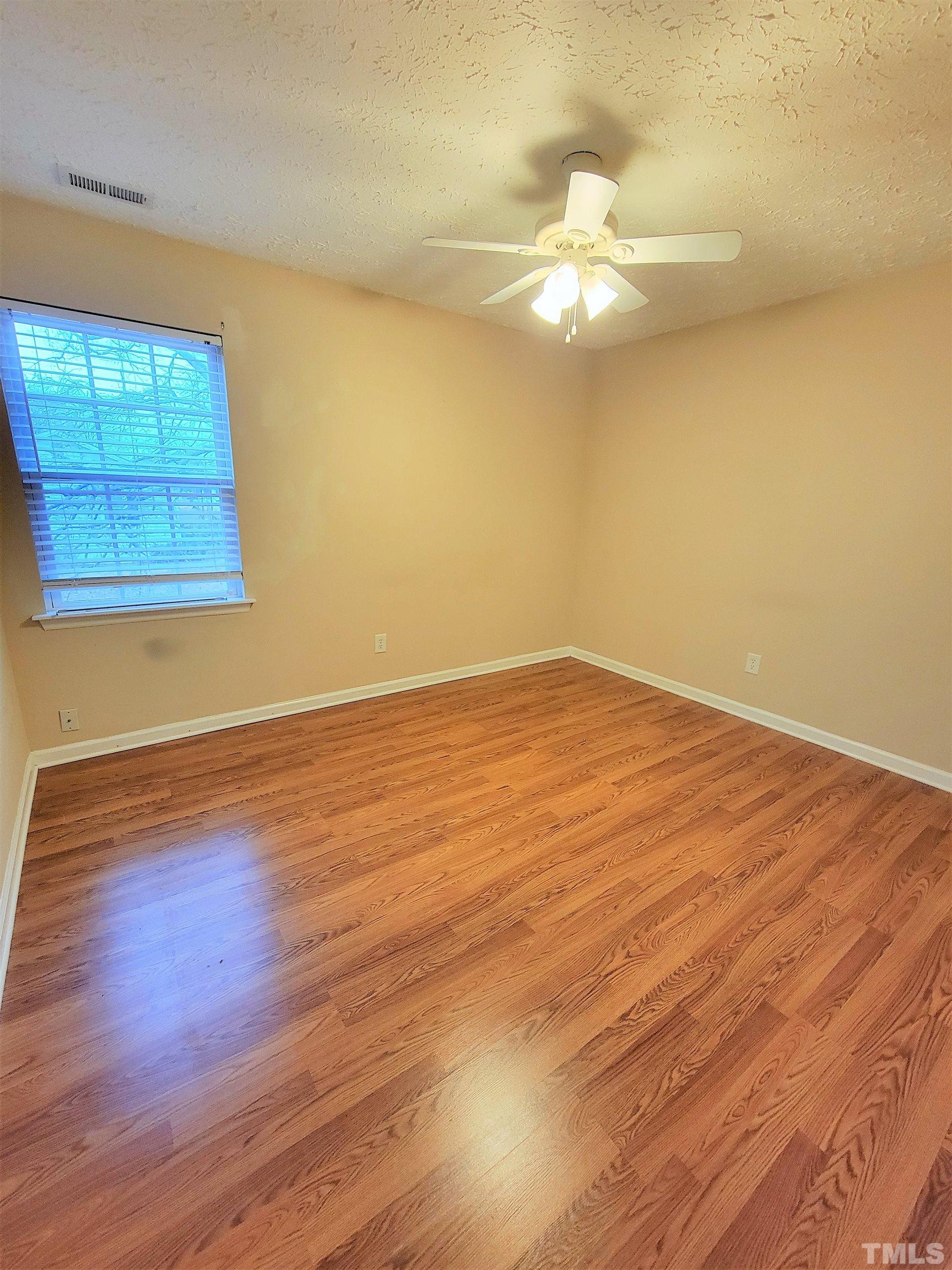 4237 Palafox Court Raleigh, NC 27604 - Photo 19 of 20 an empty room with wooden floor and windows