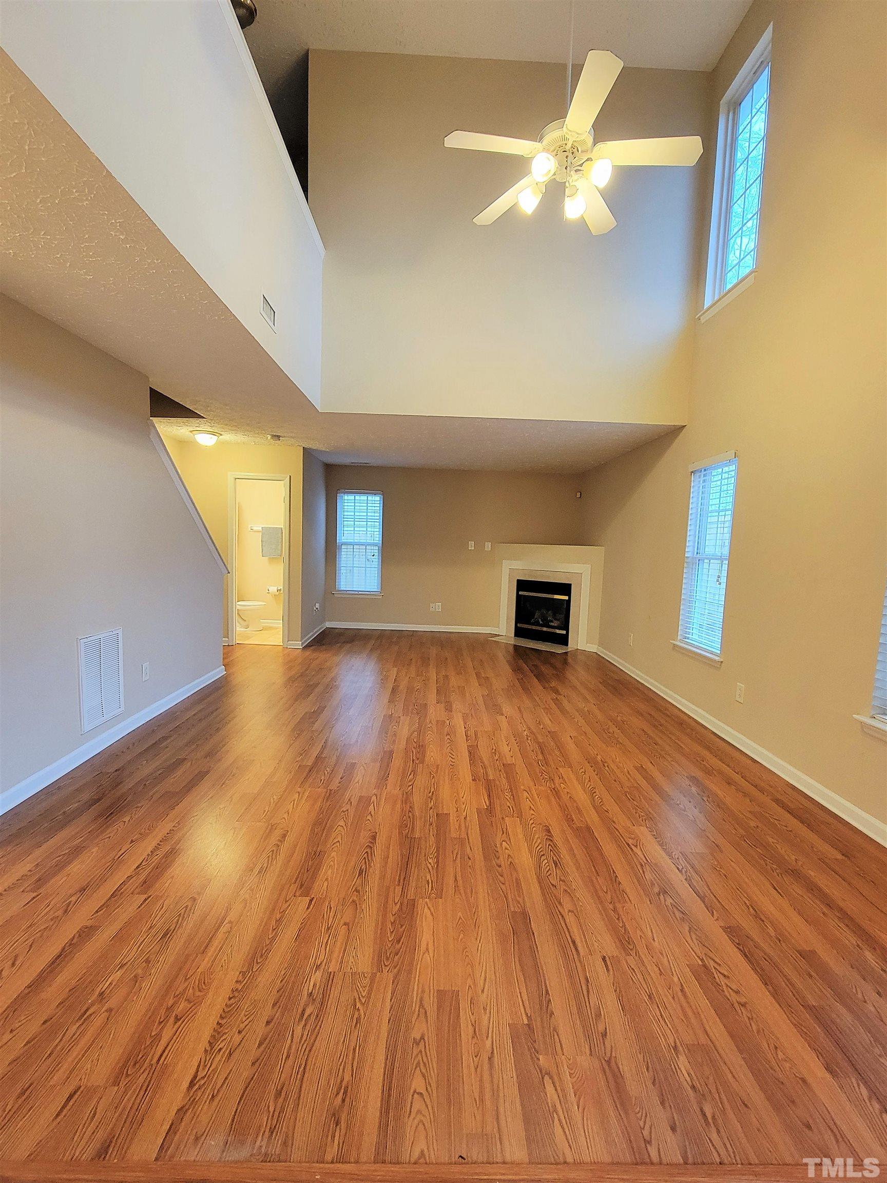 4237 Palafox Court Raleigh, NC 27604 - Photo 9 of 20 a view of a room with wooden floor and a ceiling fan
