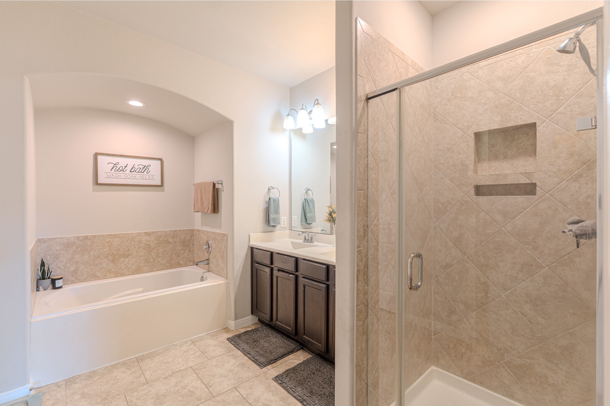 14207 Irvine Rnch Trail Conroe, TX 77384 - Photo 18 of 29 a bathroom with a bathtub and shower