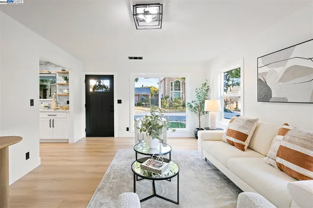 a kitchen with stainless steel appliances granite countertop a sink a stove a microwave a sink a refrigerator and cabinets