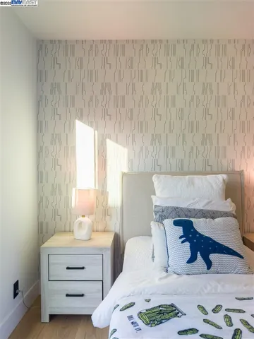 a bedroom with a bed and a mirror