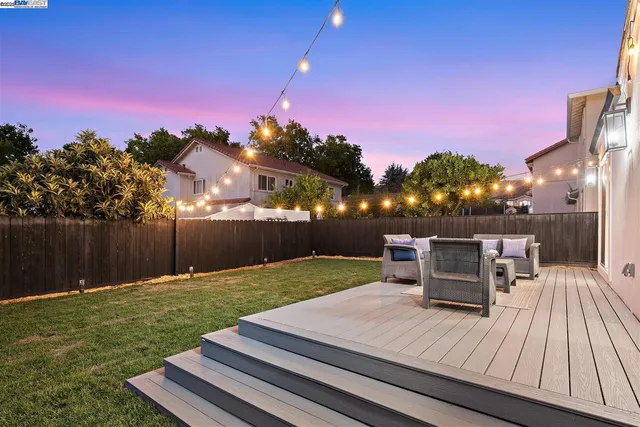 a view of a yard with wooden fence