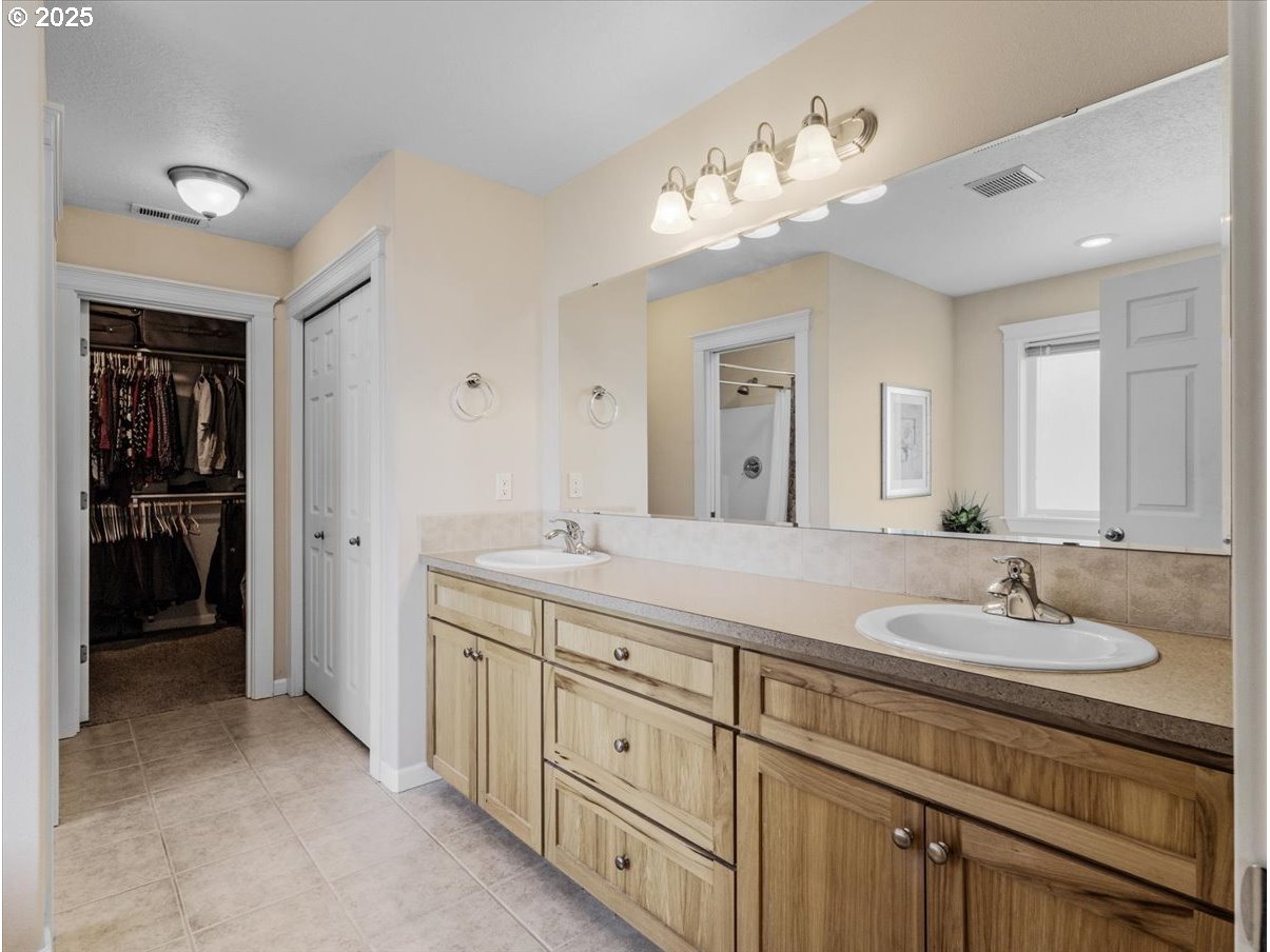 863 June Drive Molalla, OR 97038 - Photo 15 of 36 a bathroom with a double vanity sink and a mirror