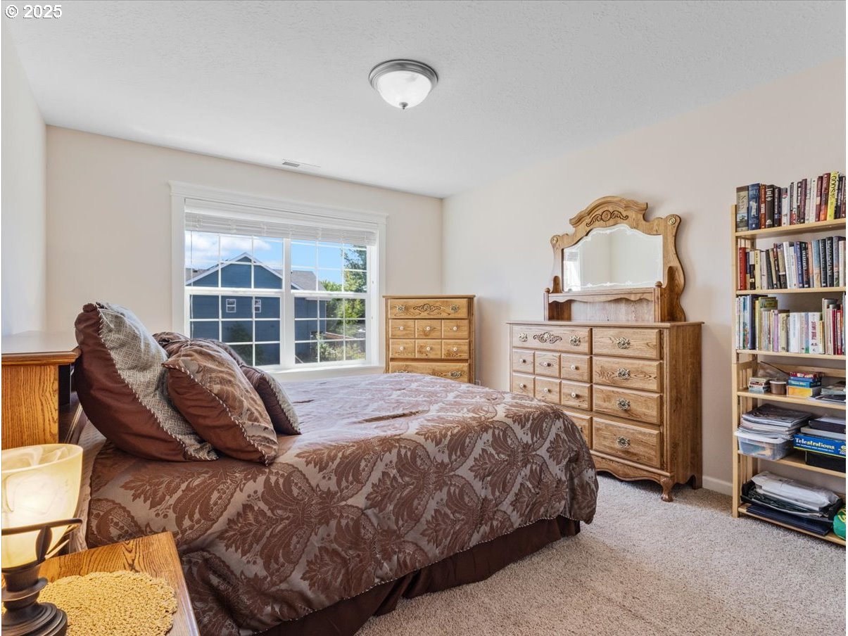 863 June Drive Molalla, OR 97038 - Photo 23 of 36 a bedroom with a bed and a book shelf