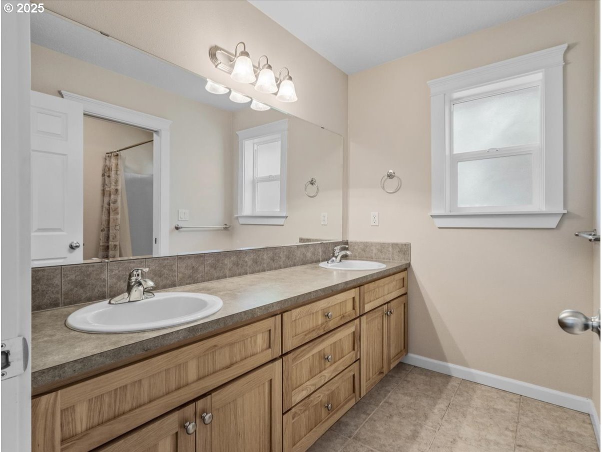 863 June Drive Molalla, OR 97038 - Photo 25 of 36 a bathroom with a granite countertop sink a large mirror and a