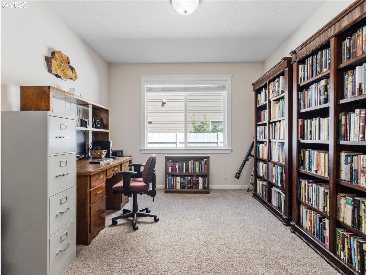 863 June Drive Molalla, OR 97038 - Photo 27 of 36 a view of a workspace with bookshelf and a window