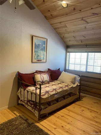 a view of a hallway with wooden floor and windows