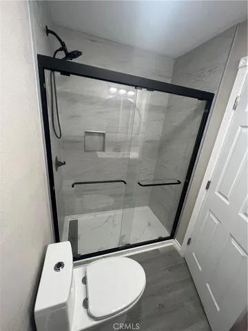 a bathroom with a toilet and a mirror