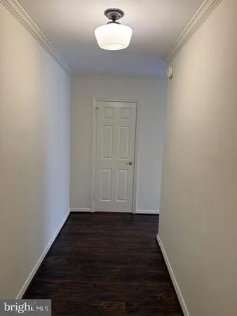 a view of a room with wooden floor and a window