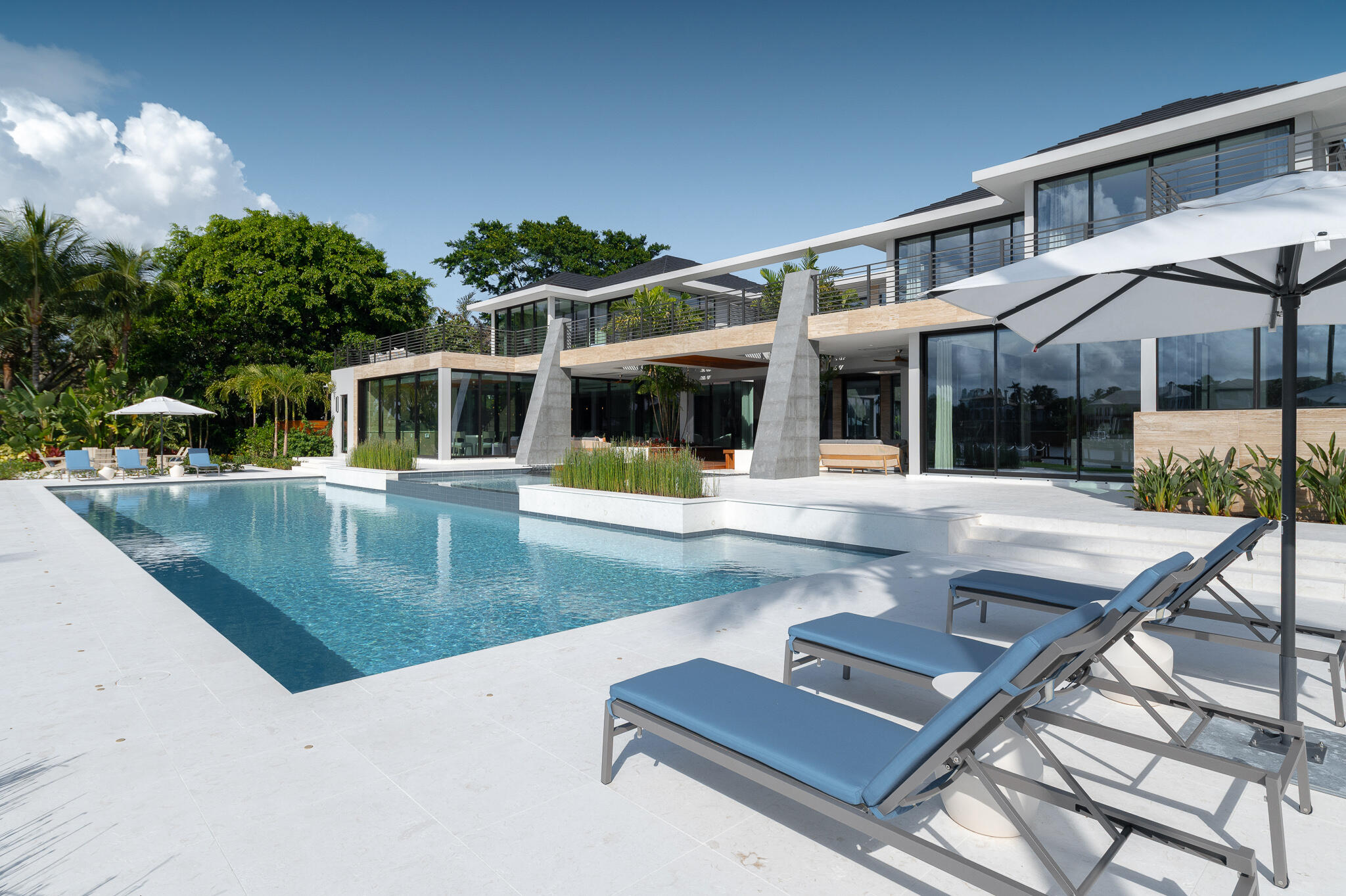488 South Beach Road Jupiter Island, FL 33455 - Photo 39 of 54 swimming pool view with a seating space and a garden