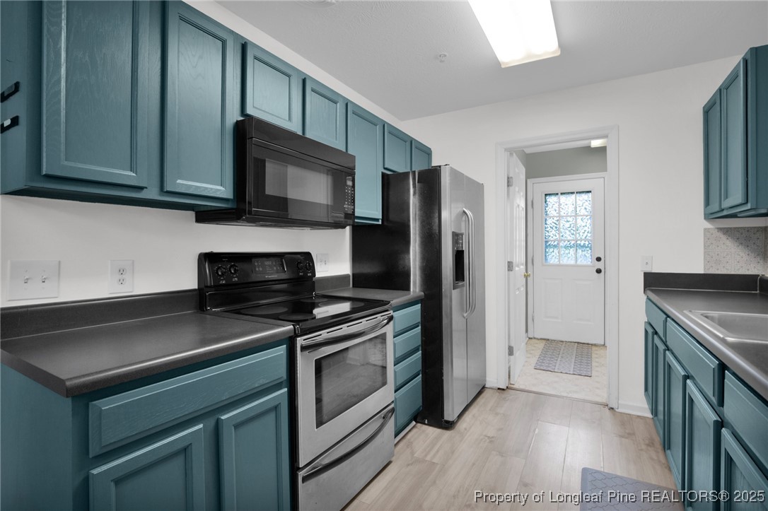 112 Madison Road Carthage, NC 28327 - Photo 12 of 27 a kitchen with stainless steel appliances granite countertop a stove microwave and refrigerator