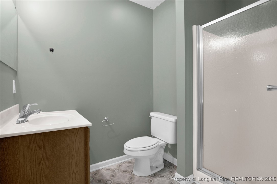 112 Madison Road Carthage, NC 28327 - Photo 17 of 27 a bathroom with a sink toilet and vanity