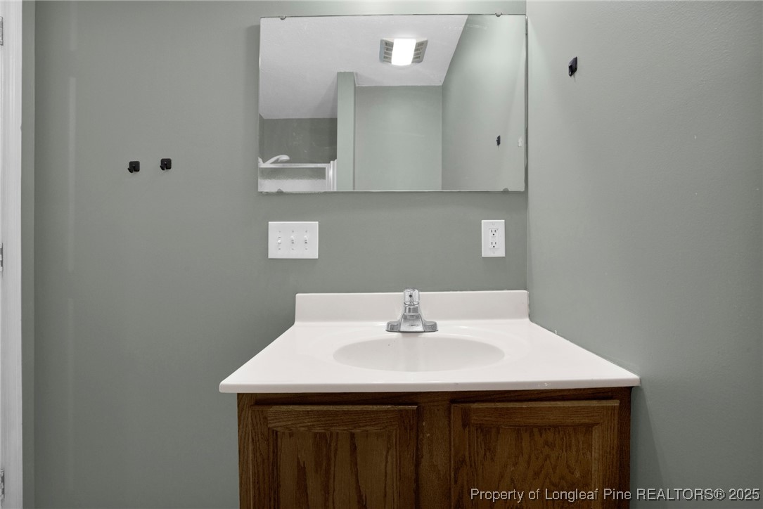 112 Madison Road Carthage, NC 28327 - Photo 18 of 27 a bathroom with a sink and a mirror