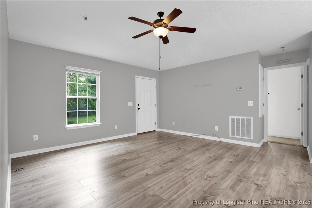 112 Madison Road Carthage, NC 28327 - Photo 5 of 27 a view of an empty room with window and wooden floor