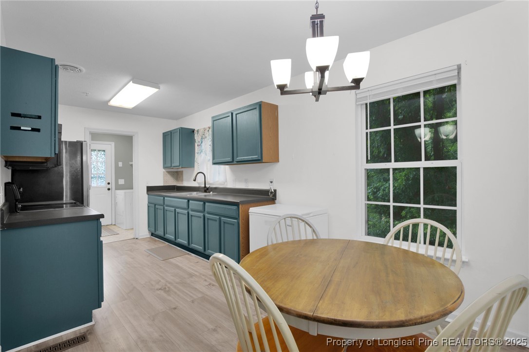 112 Madison Road Carthage, NC 28327 - Photo 10 of 27 a kitchen with kitchen island a sink appliances and a counter top space