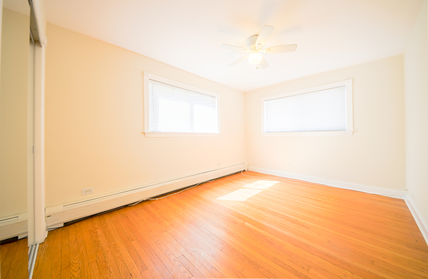 1308 Perry Street, Unit B Des Plaines, IL 60016 - Photo 7 of 11 a view of a room with a wooden floor and a window