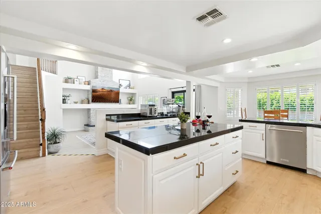 a kitchen with stainless steel appliances a sink stove and cabinets