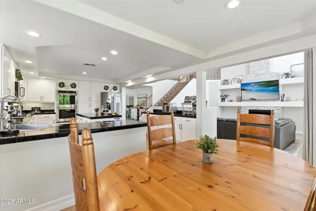 a kitchen with stainless steel appliances kitchen island granite countertop a sink and cabinets