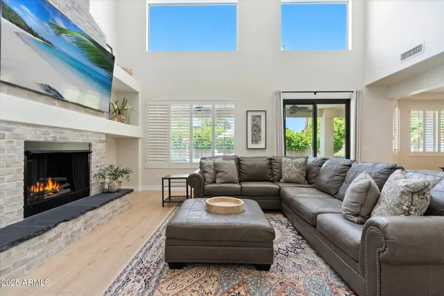 a living room with furniture and a fireplace