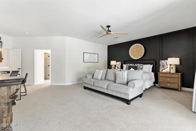 a bedroom with a bed a mirror and a window