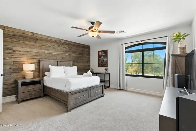 a bedroom with a bed and a mirror