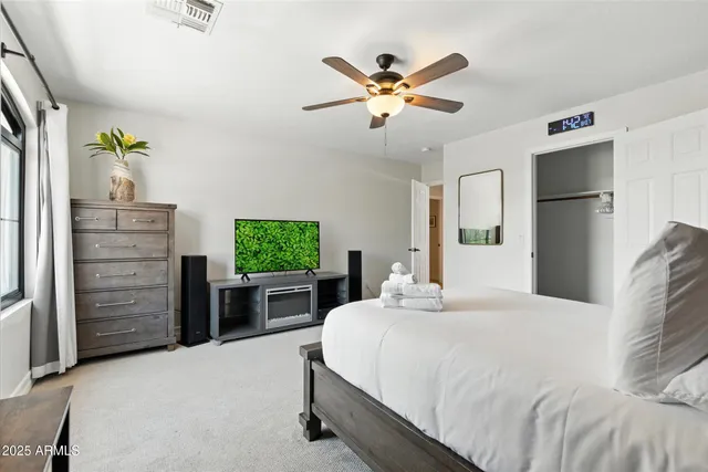 a bedroom with a bed and a fireplace