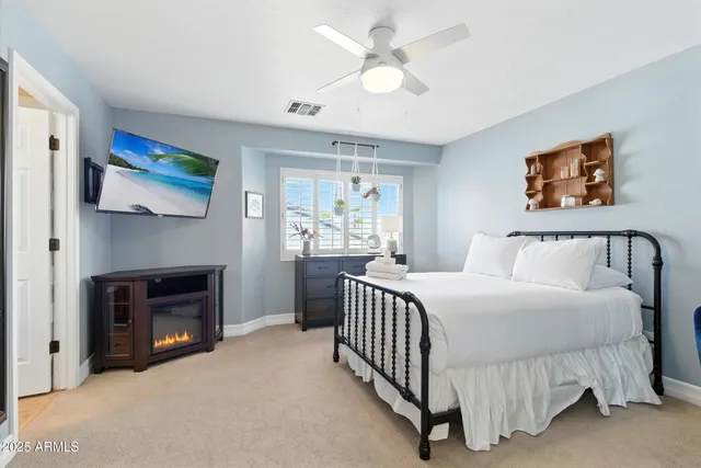 a bedroom with a bed and a television