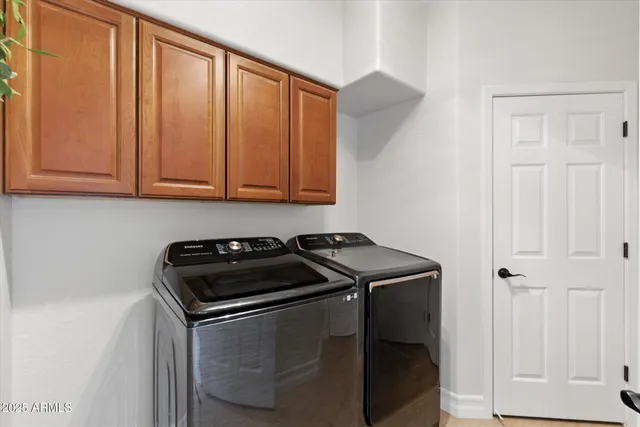a view of a swimming pool with a table and chairs under an umbrella