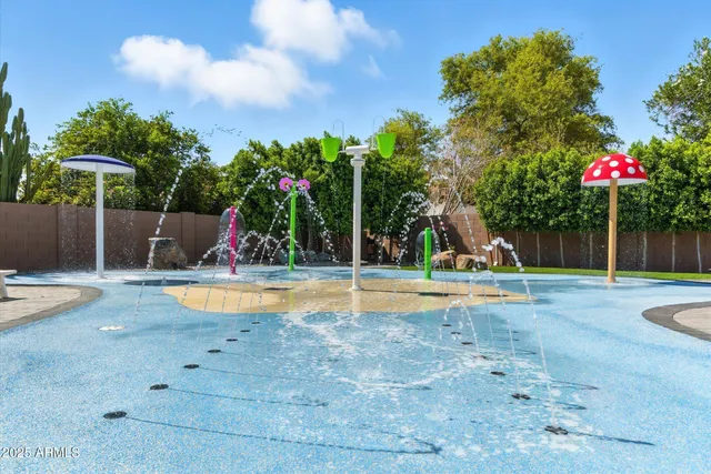 a view of a backyard with swimming pool