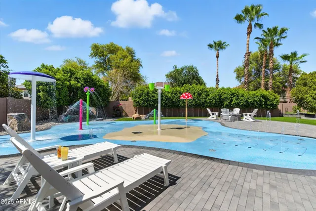 a view of a backyard with swimming pool