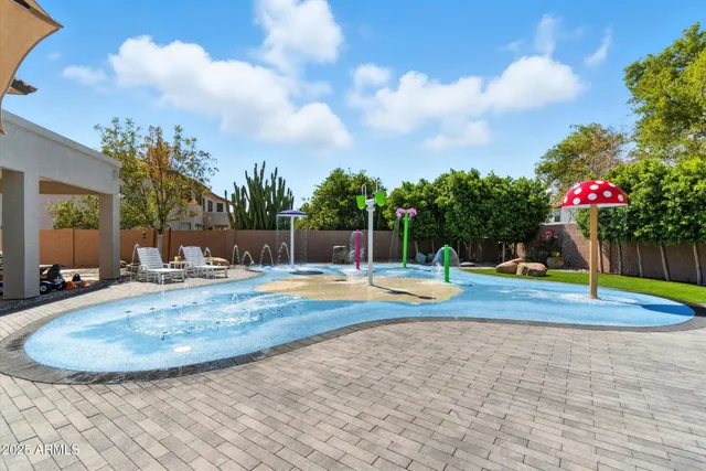 a view of a house with swimming pool and sitting area