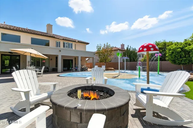 a view of a house with a backyard porch and sitting area