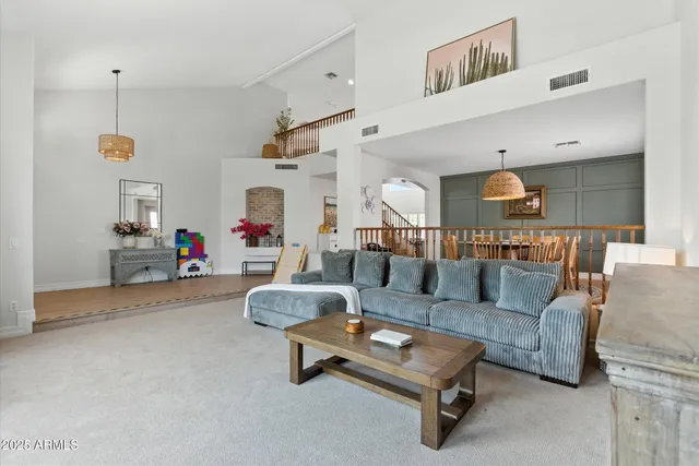 a living room with furniture and a dining table