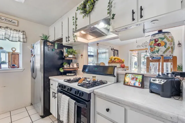 a kitchen with stainless steel appliances granite countertop a stove a refrigerator and a refrigerator