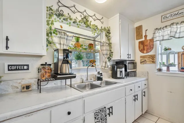 a bathroom with double vanity sink and a mirror