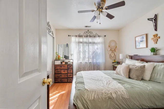 a bedroom with a bed and a chandelier