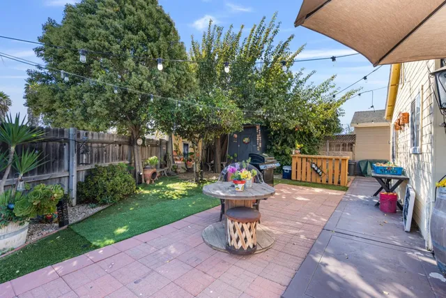 a backyard of a house with table and chairs