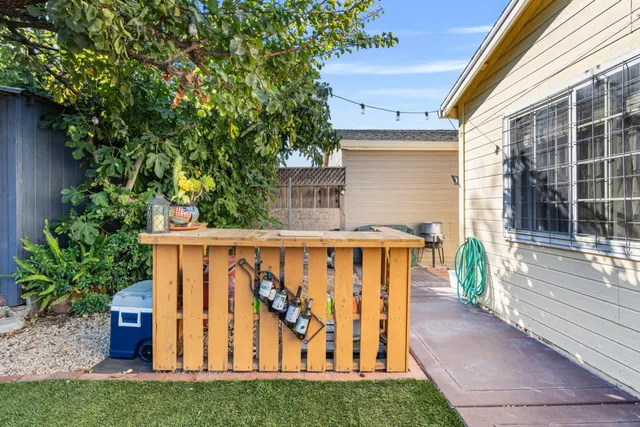 a view of a patio with table and chairs and wooden floor
