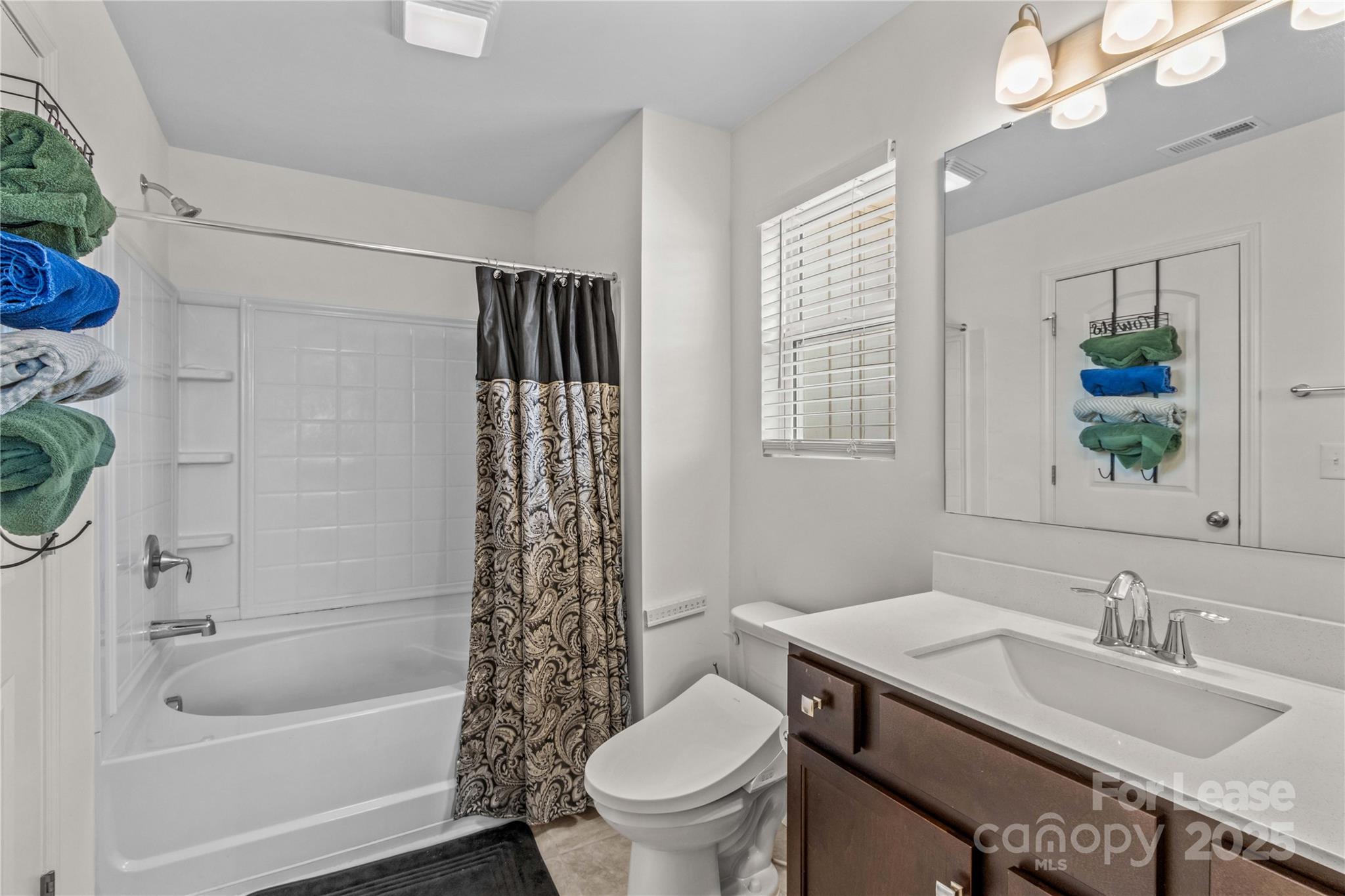 125 Mooring Drive Statesville, NC 28677 - Photo 17 of 32 a bathroom with a granite countertop sink a toilet a mirror a vanity a bathtub and shower