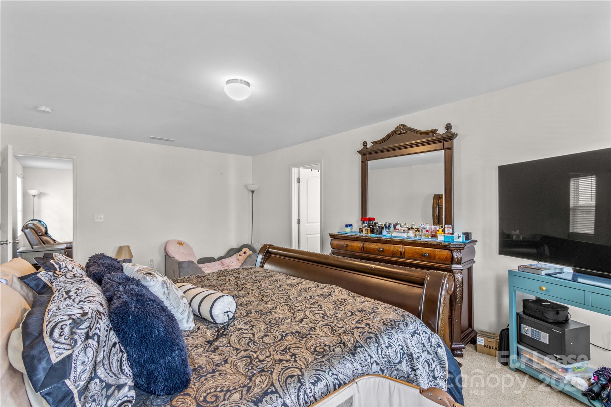 125 Mooring Drive Statesville, NC 28677 - Photo 19 of 32 a bedroom with bed and flat tv screen on dresser