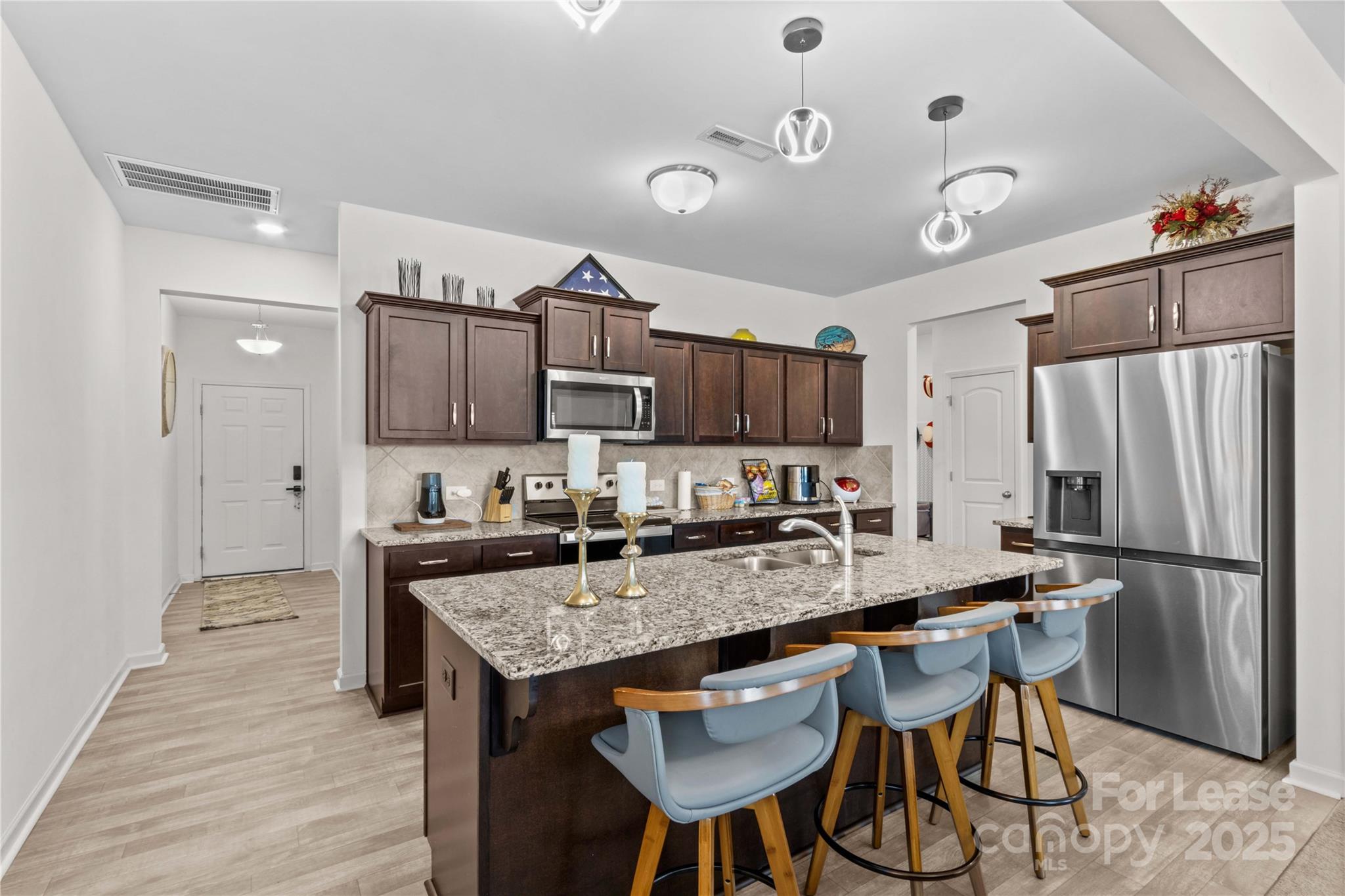 125 Mooring Drive Statesville, NC 28677 - Photo 4 of 32 a kitchen with granite countertop a table chairs microwave and refrigerator