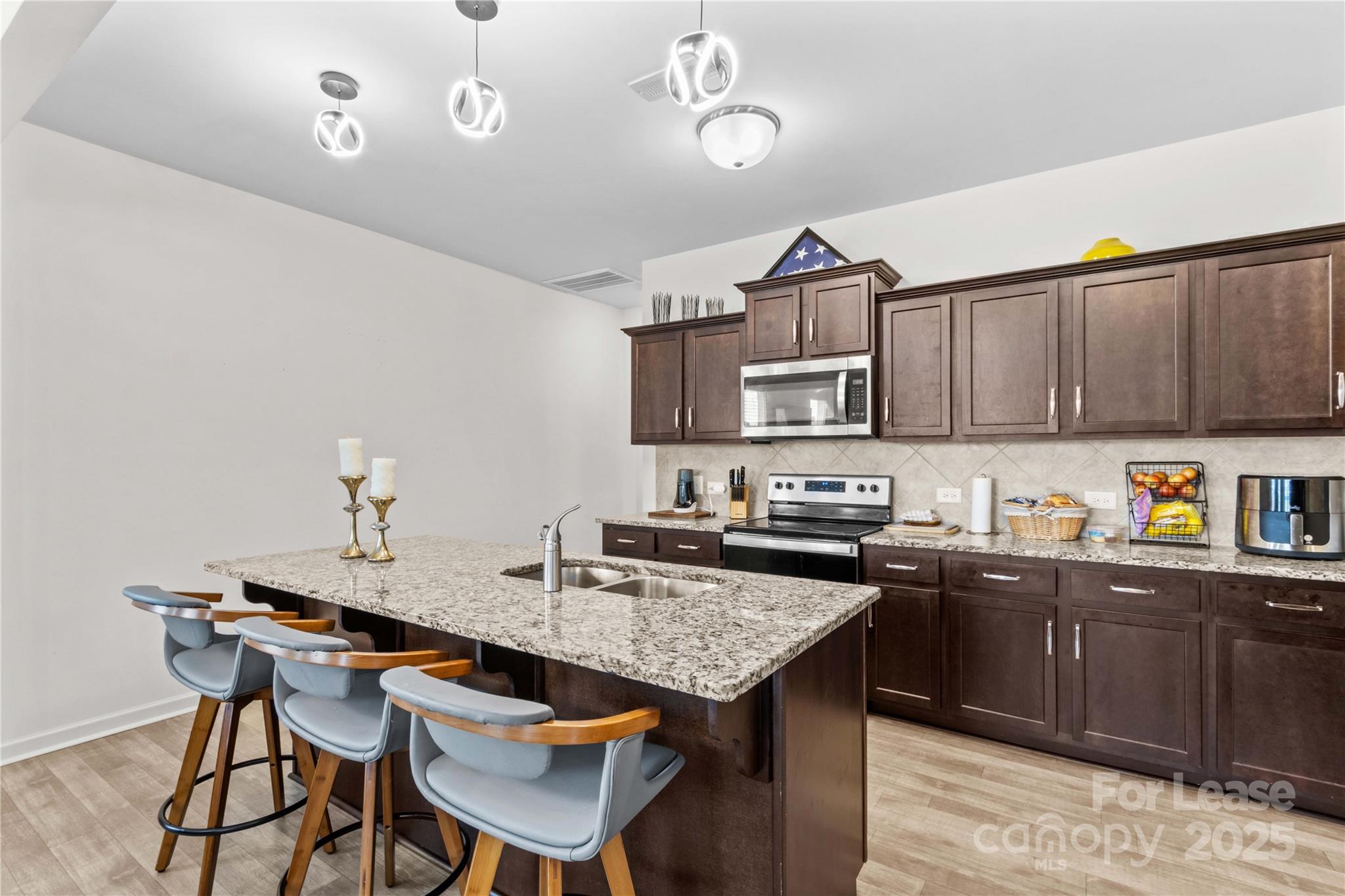 125 Mooring Drive Statesville, NC 28677 - Photo 5 of 32 a kitchen island with granite countertop a sink and cabinets